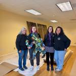 Memebers of the North Bend Art & Industry board of directors stand for a photo in its new maker space, Feb. 7, 2025. Grace Gorenflo/Valley Record