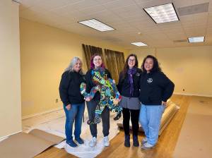 The North Bend Art & Industry board of directors stands for a photo in its new maker space, Feb. 7, 2025. (Grace Gorenflo/Valley Record)