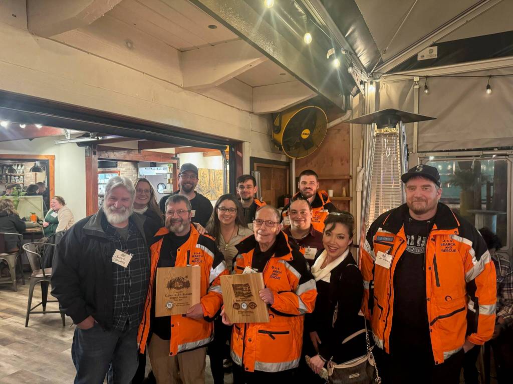 The King County Search and Rescue Association, known as KCSARA, held its 60th anniversary celebration Feb. 13 at the South Fork Restaurant in North Bend. Pictured: King County 4x4 SAR with Bob Gordon, Milestone Marvel award recipient with 50 years of volunteer service (center). Photo by Ben Klassen