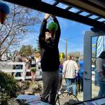 Owner Larry Brown hangs ice cream cone decorations outside Mooo! Ice Cream during its grand opening April 5, 2025. Grace Gorenflo/Valley Record