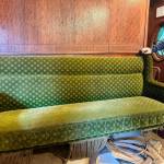 A bench set in parlor car 1049 with the original green mohair fabric, April 29, 2025.
