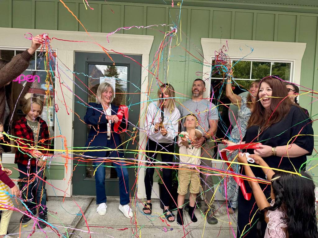 Works from the heART owner Ashley James celebrates with friends, family and community members after cutting the ribbon at her opening in downtown North Bend, July 10, 2025. (Grace Gorenflo/Snoqualmie Valley Record)