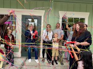Works from the heART owner Ashley James celebrates with friends, family and community members after cutting the ribbon at her opening in downtown North Bend, July 10, 2025. (Grace Gorenflo/Snoqualmie Valley Record)