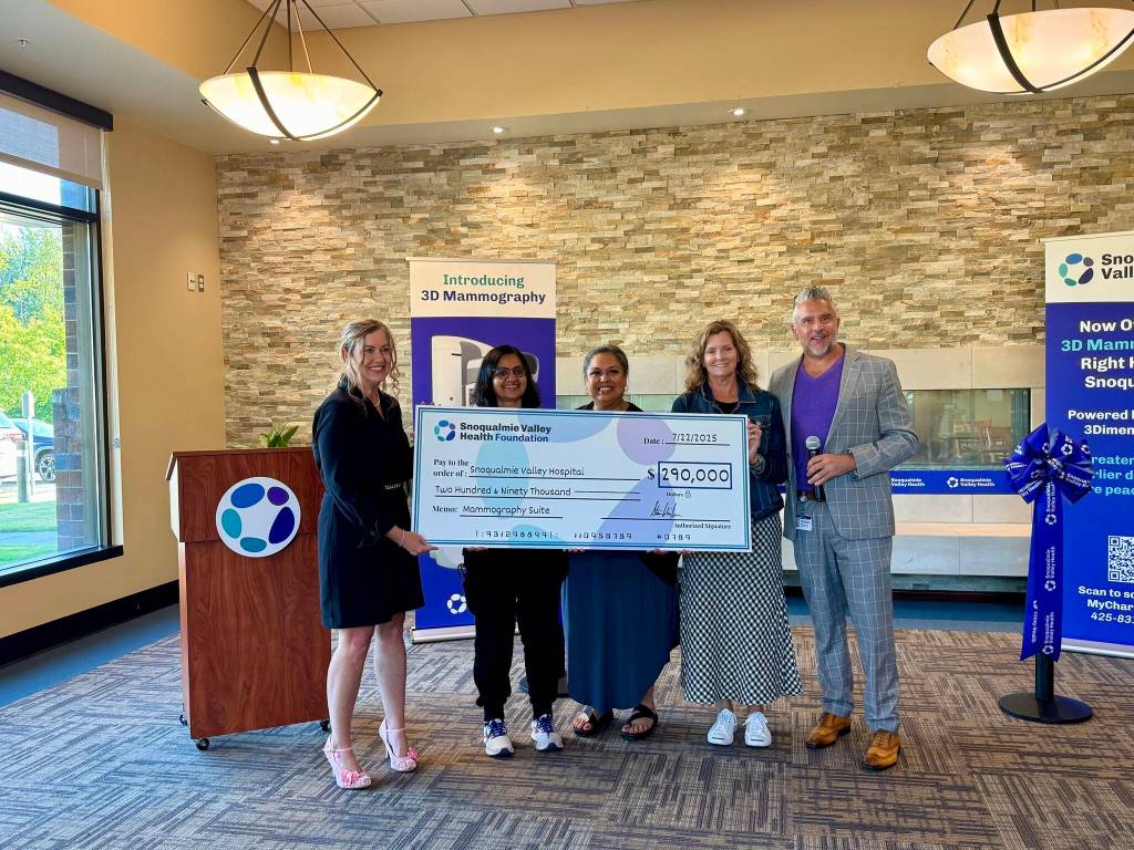 The Snoqualmie Valley Health Foundation presents the hospital with a check for $290,000 to support the new mammography suite, July 22, 2025. (Grace Gorenflo/Valley Record)