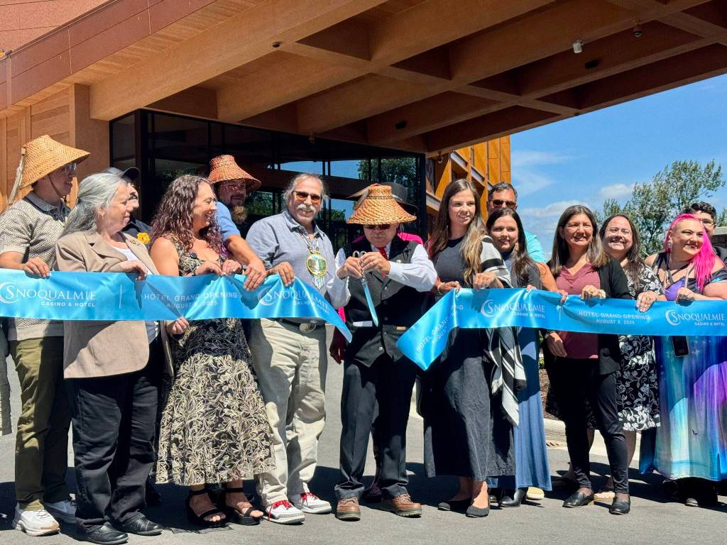 Robert de los Angeles, chairperson of the Snoqualmie Tribal Council, cuts the ribbon at the opening of the Snoqualmie Casinos hotel, surrounded by tribal members, Aug. 8, 2025. (Grace Gorenflo/Valley Record)
