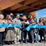 Robert de los Angeles, chairperson of the Snoqualmie Tribal Council, cuts the ribbon at the opening of the Snoqualmie Casinos hotel, surrounded by tribal members, Aug. 8, 2025. (Grace Gorenflo/Valley Record)