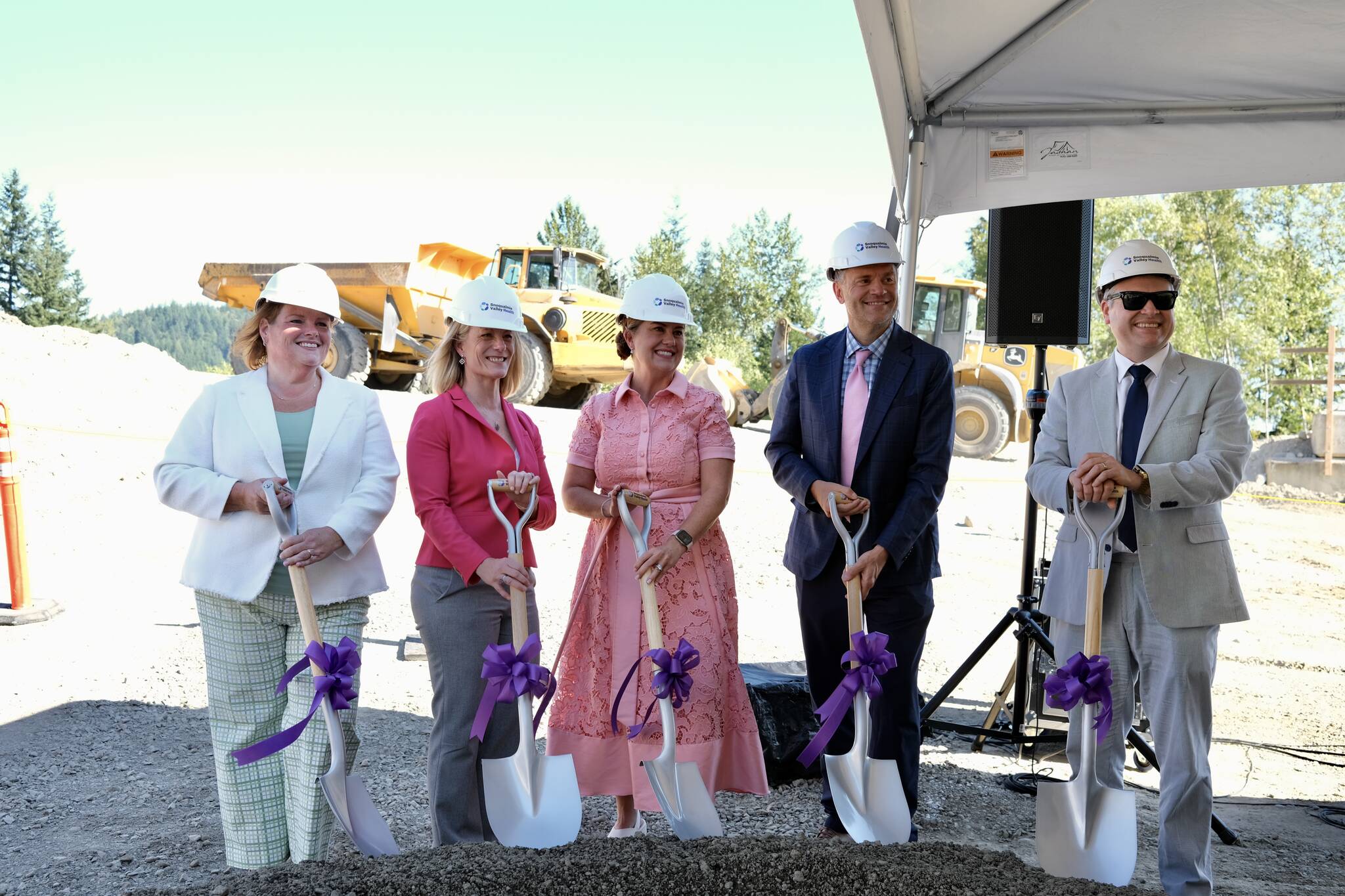Snoqualmie Valley Health executives stand shovel-ready at the groundbreaking ceremony for the HUB, Aug. 22, 2025. From left: Chief Nursing Executive Tricia Ralston; Chief of Strategic Operations Tammy Moore; CEO Renee Jensen; Chief Medical Officer Jeremey Storm; CFO Patrick Ritter. Photo by Grace Gorenflo/Valley Record