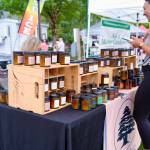A customer makes a purchase from Snoqualmie Valley Candle Company at the North Bend Farmers Market, Sept. 11, 2025. Photos by Grace Gorenflo/Valley Record