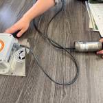 Floodzilla field scientist Regina Fletcher shows a Floodzilla gauge and transmitter not in use, Aug. 6, 2025. (Grace Gorenflo/Valley Record)