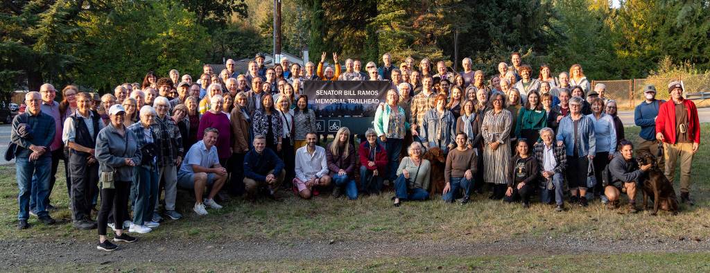 Issaquah community members gather around a trailhead marker named after late Sen. Bill Ramos at its unveiling, Oct. 6, 2025. Photo courtesy of the city of Issaquah