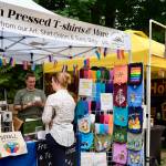 Fresh-pressed t-shirts and bags are for sale, including those with the Duvall Famers Market logo, at the market Sept. 4, 2025. (Grace Gorenflo/Valley Record)