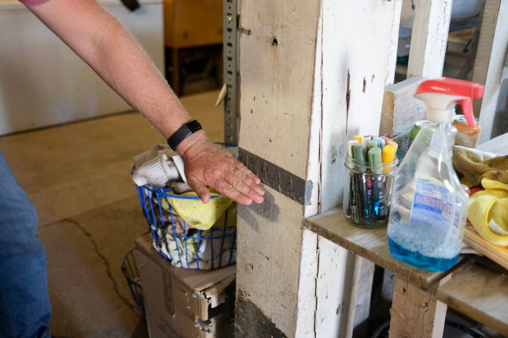 David Haakenson, owner of Jubilee Farm, shows the mark inside his barn where the water rose during the 2009 flood, Sept. 16, 2025.