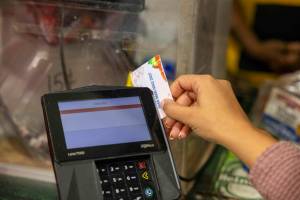 A shopper who receives SNAP benefits slides an EBT card at a checkout counter in a Washington, D.C., grocery store in December 2024. ( U.S. Department of Agriculture)