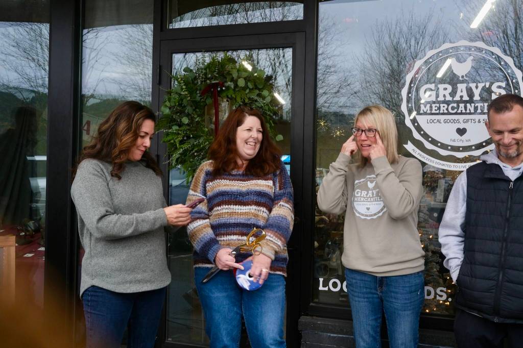 Grays Mercantile founder Summer Stumpf holds back tears at the Grays Mercantile ribbon-cutting ceremony, Nov. 15, 2025. From left: Fall City Community Association Vice President Sarah Kieffer; SnoValley Chamber CEO Kelly Coughlin; Summer Stumpf; Aaron Stumpf. (Grace Gorenflo/Valley Record)