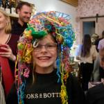 Owner Julie Thomass daughter celebrates the Books and Bottles ribbon cutting with streamers on her head, Nov. 14, 2025. Photos by Grace Gorenflo/Valley Record