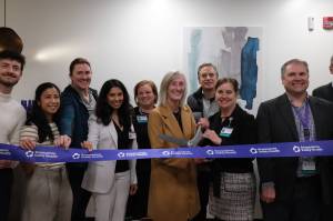 Snoqualmie Valley Health CEO Renee Jensen (right) and North Bend Mayor Mary Miller cut the ribbon on the new clinic, Nov. 19, 2025. They are surrounded by SVH providers and leaders. (Grace Gorenflo/Valley Record)