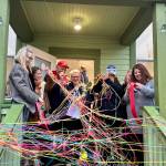 Chaplain Patti Yetneberk cuts the ribbon at the new Snoqualmie Valley Healing Center, Nov. 6, 2025. (Grace Gorenflo/Valley Record)