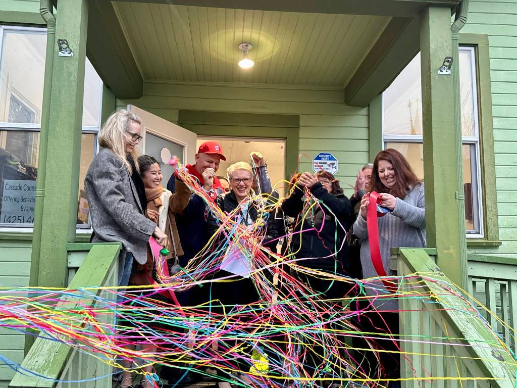 Chaplain Patti Yetneberk cuts the ribbon at the new Snoqualmie Valley Healing Center, Nov. 6, 2025. (Grace Gorenflo/Valley Record)
