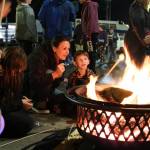 Destiny Lasnik helps her son Atlas, 6, roast a marshmallow at the Holly Days festival in North Bend on Saturday, Dec. 6. A two-block stretch of North Bend Way was closed to cars to make room for firepits, vendor tents and a performance stage. Photos by Aaron Gustafson