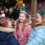 Sisters Alexia and Alice play with friend Stella (left to right) while waiting in line to have their pictures taken with Santa at the Christmas in Carnation event.