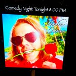 A poster on display outside the window of the Tin Room Theater the night of Andrew Rivers show. Photo by James Gibowski