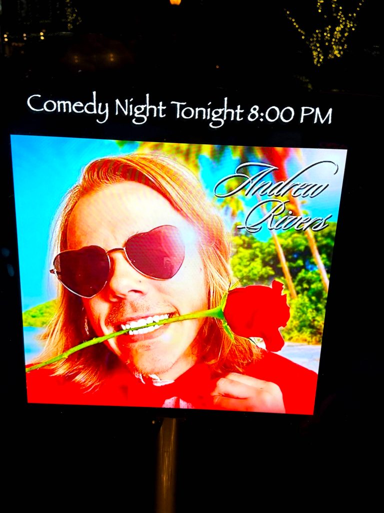 A poster on display outside the window of the Tin Room Theater the night of Andrew Rivers show. Photo by James Gibowski