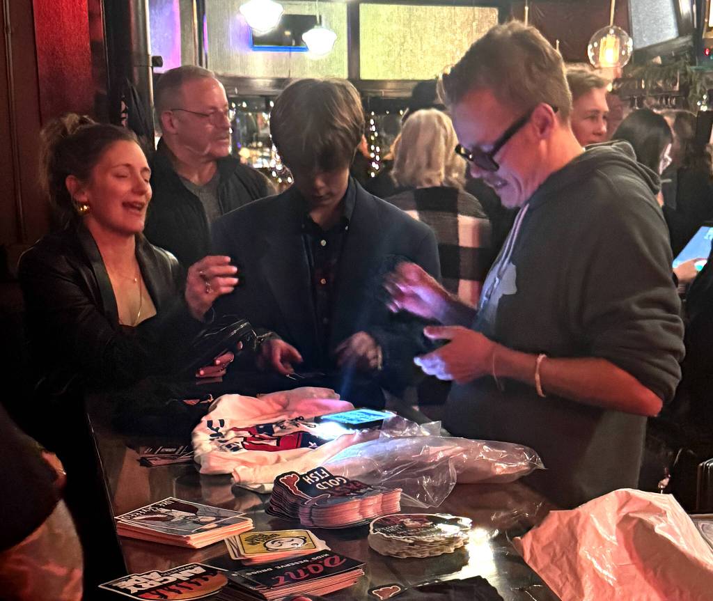 West Seattles Jennifer Margolis purchases some Andrew Rivers merchandise after his show at Buriens Tin Room Theater. Photo by James Gibowski