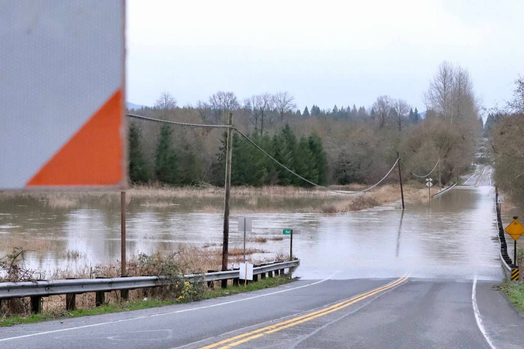 Flood waters flow over NE 124th Street at West Snoqualmie Valley Road NE outside Duvall, Dec. 9, 2025. Photos by Grace Gorenflo/Valley Record