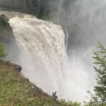 The Snoqualmie River shoots over Snoqualmie Falls the morning of Dec. 9, 2025. As flooding hit the Snoqualmie Valley, the falls essentially created their own weather system, with water pouring down on those who stood near. (William Shaw/Valley Record)