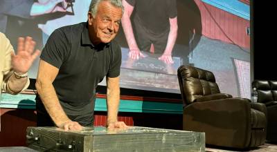 Actor Ray Wise, who played Leland Palmer in Twin Peaks, imprints his hands in a block of wet concrete at the North Bend Theatre, Feb. 22, 2025. The concrete block was added to the sidewalk outside the theater. (Grace Gorenflo/Valley Record)