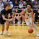 Mount Si High School guard Latt Ford drives toward the basket against Lake Washington in their 67-60 victory Feb. 21 in the district championship. The Wildcats face West Valley on Feb. 28 in the opening round of the WIAA class 4A boys state basketball playoffs.