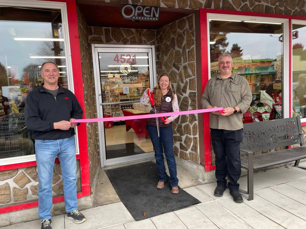 Photo courtesy of the city of Carnation
Carnation Ace Hardware co-owner Ron Cox (left) helps Carnation Co-op manager Sophia Marchetti (middle) and company general manager Mike Lukjanowicz cut the ribbon on the new shop, March 6, 2026.