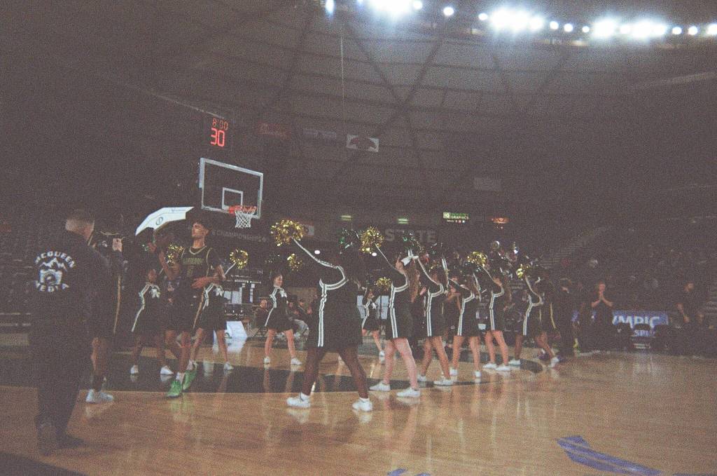 Auburn High School cheerleaders welcome their starting players to the floor. Ben Ray / Sound Publishing