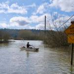 Felix Salvo, 15, rows his familys boat through flood waters on NE 124th Street, March 20, 2026. His parents own Local Roots Farm in Duvall. (Grace Gorenflo/Valley Record)