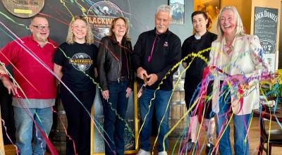 Owner Greg Steed (center) celebrates with friends and family after cutting the ribbon at Blackwater Brewing, April 2, 2026. (Grace Gorenflo/Valley Record)