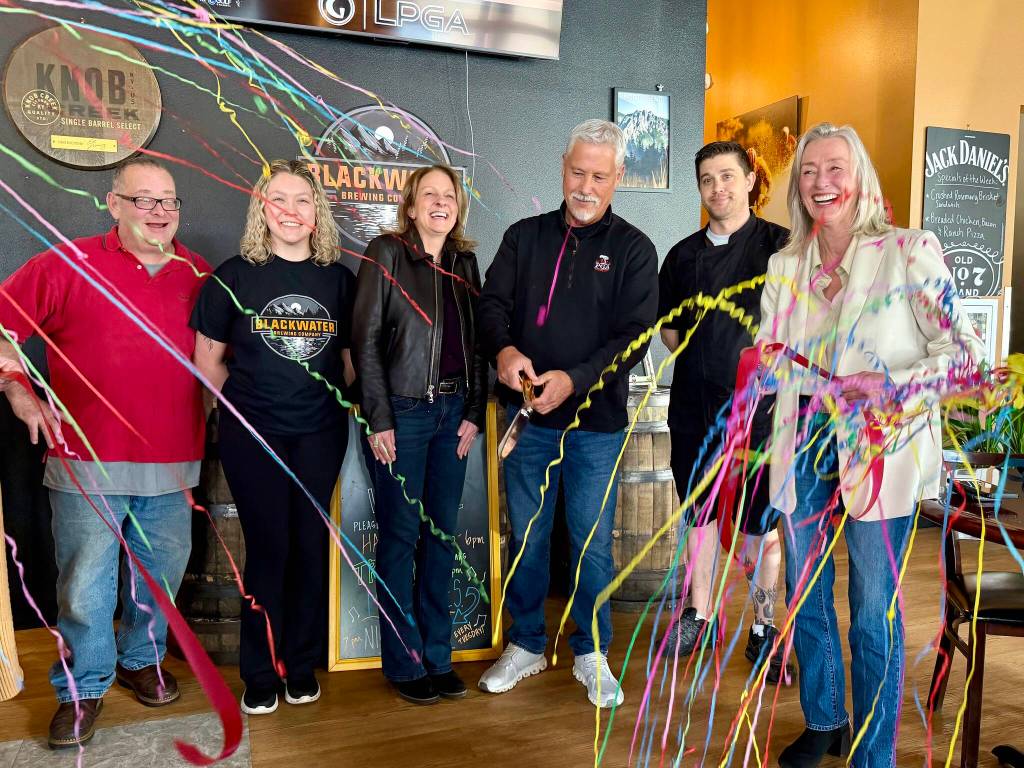 Owner Greg Steed (center) celebrates with friends and family after cutting the ribbon at Blackwater Brewing, April 2, 2026. (Grace Gorenflo/Valley Record)