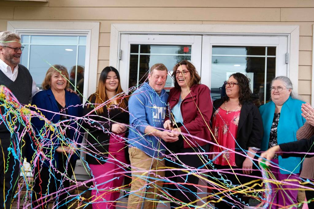 Angela Donaldson (center right), surrounded by peers and family, celebrates after cutting the ribbon at the grand opening of her insurance agency, March 24, 2026. (Grace Gorenflo/Valley Record)