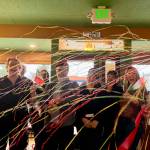 Photos by Grace Gorenflo/Valley Record
The Burrowses celebrate after cutting the ribbon at Paisan Ristorante with their staff and local leaders, April 1, 2026.