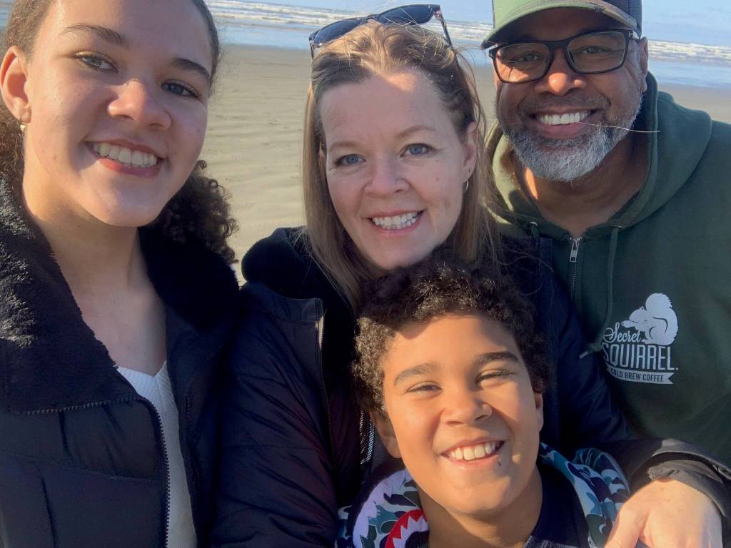 Photo courtesy of Trevor Smith
Trevor Smith (right) with his wife and children at the beach.