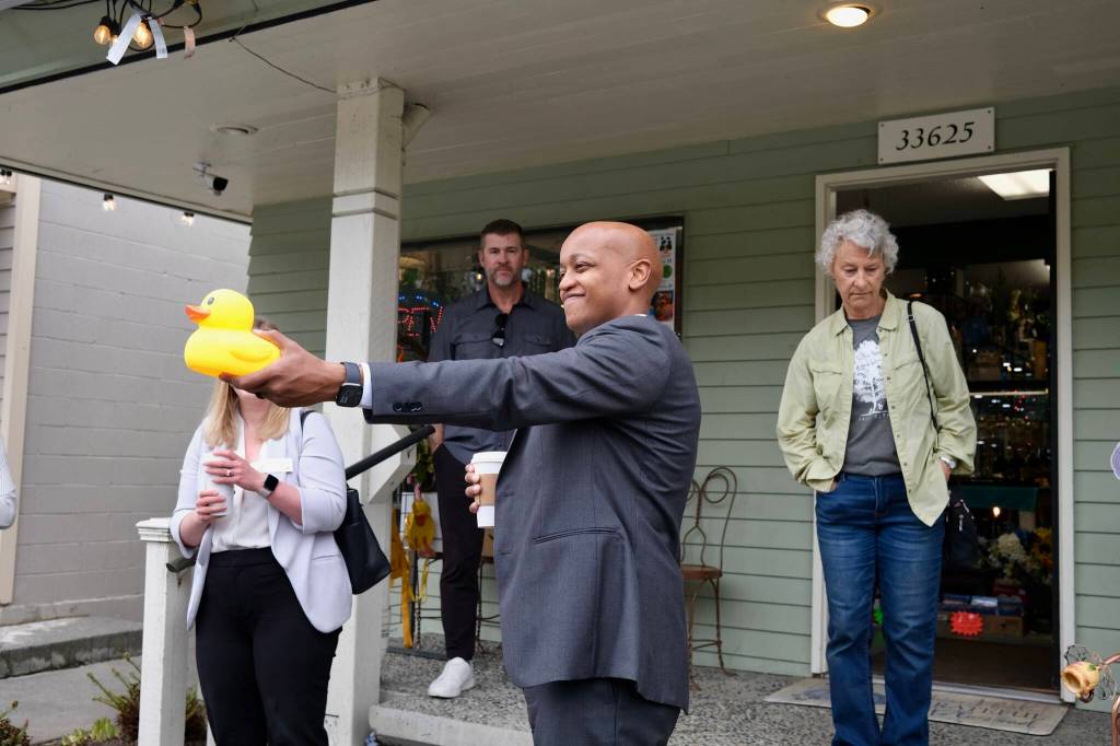 King County Executive Girmay Zahilay stands for a photo with a rubber duck from Lucky Duck Thrift Shoppe in Fall City, May 5, 2026. (Grace Gorenflo/Valley Record)