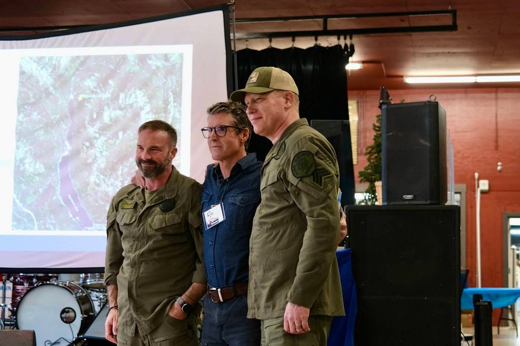 Grace Gorenflo / Valley Record
Two Search and Rescue members stand with a man they rescued last year after telling their story at SARposium, May 14, 2026.