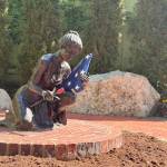 A statue depicting a woman with a rose and a folded American flag at the Snoqualmie Veterans Memorial. The statue, provided by Post 79, represents the spouses of fallen service members and is surrounded by names of the fallen. Photo by Faith Ellis for the Valley Record