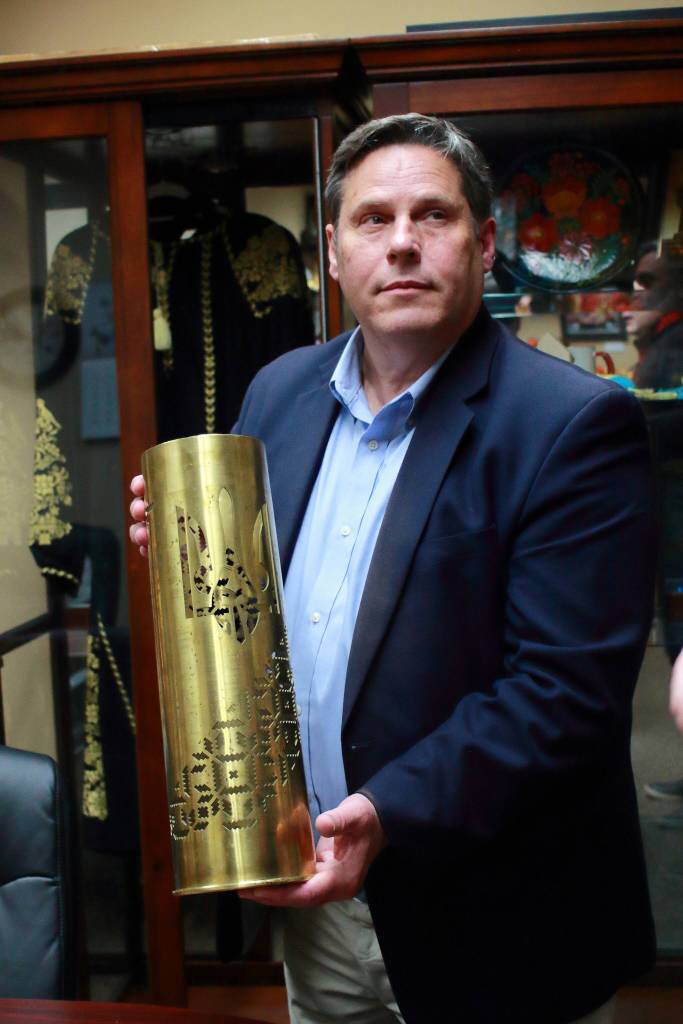 Mayor Jim Ferrell holds an artillery shell with the emblem of Ukraine engraved in it - a gift from Federal Ways sister city of Rivne, Ukraine.