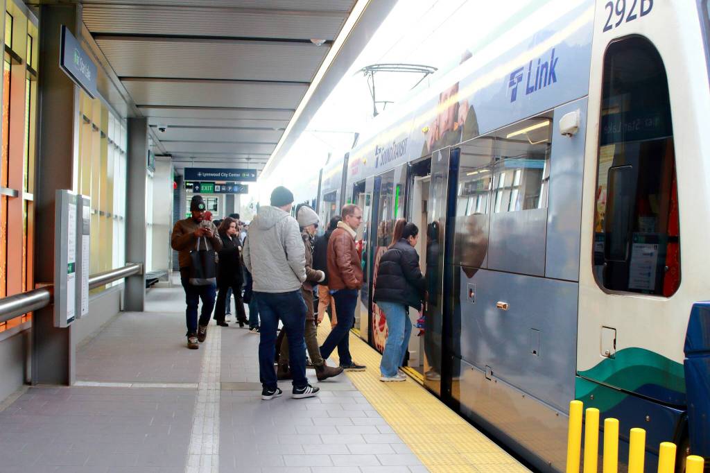 Many public transportation options are available for those looking to avoid street traffic during the World Cup. Pictured: Crowds board the Sound Transit Link Light Rail at Star Lake station. File photo