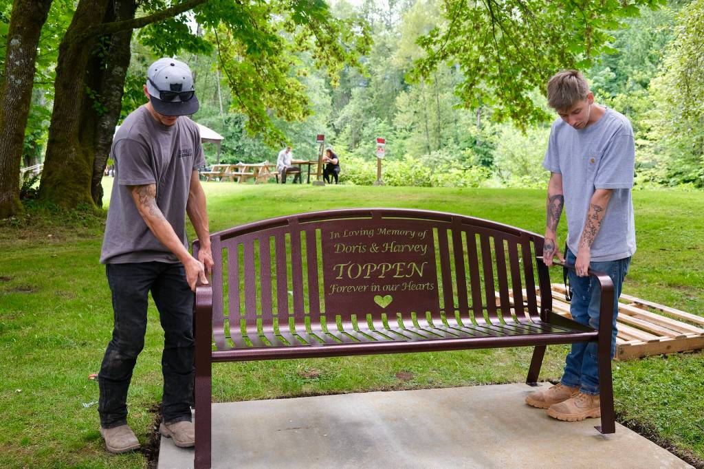 Grace Gorenflo / Valley Record
SnoValley Concrete Services installs the Doris & Harvey Toppen memorial bench in North Bend, July 2, 2026.