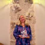 Nicole Perriella-Rehmke with her new book, She Decided, at Books & Bottles, July 16, 2026. (Grace Gorenflo/Valley Record)