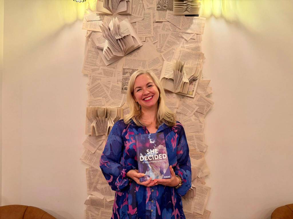 Nicole Perriella-Rehmke with her new book, She Decided, at Books & Bottles, July 16, 2026. (Grace Gorenflo/Valley Record)