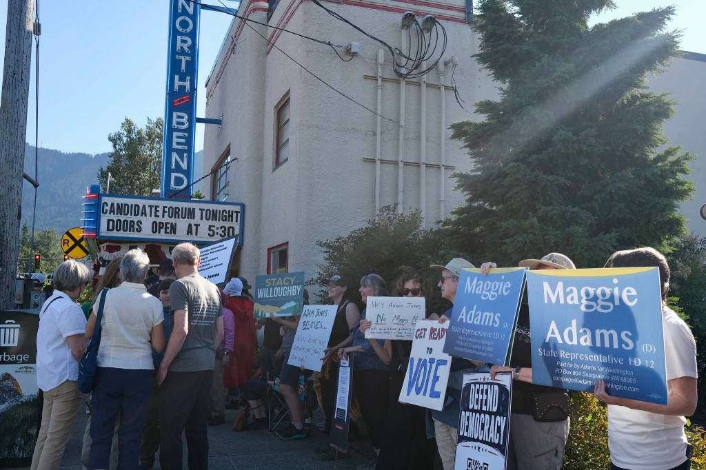 Grace Gorenflo/Valley Record
Protestors stand outside North Bend Theatre during a primary candidate forum July 14, 2026.