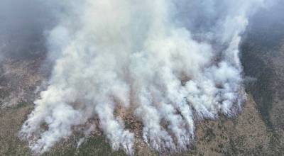 The Ptarmigan Fire burning in Washingtons Pasayten Wilderness, as seen in this aerial photo taken by smokejumpers July 20, has crossed the Canadian border and burned at least 18,000 acres so far. State leaders in Oregon and Washington have called for reinforcements and expect a grueling August. (Photo courtesy of U.S. Forest Service)